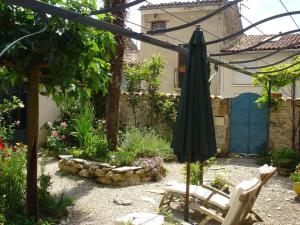 DourgneにあるLe Pastel de l'Autanのパティオ(パラソル、椅子付)、庭園