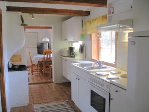 a kitchen with a sink and a stove top oven at Tildas Urshult in Urshult