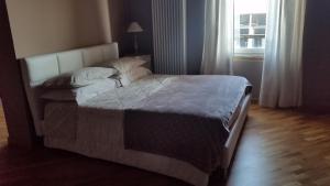 a large bed in a bedroom with a window at B&B La Palazza in Russi