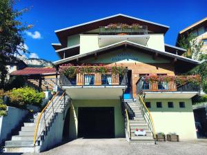 a building with flower boxes on the balconies at Garni Enrosadira in Vigo di Fassa