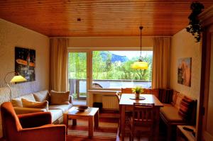 a living room with a couch and a table at Bavarian Holiday Hideaway in Pfronten
