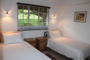En eller flere senge i et værelse på Klipkopje Guest Cottage