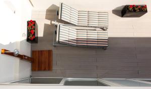 a room with a wall with two windows at Faro Boutique Hotel in Faro +28 photos