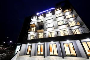 a building with lights on top of it at night at Jeju Jungmun Ocean Blue Hotel in Seogwipo