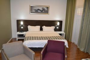 Rúm í herbergi á Havana Hotel