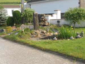 a garden with a bunch of birds in the grass at Lletygwilym, Heol dwr in Kidwelly