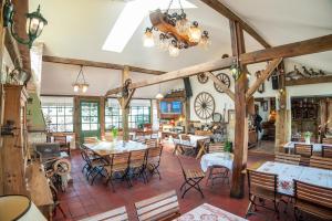 a dining room with wooden tables and chairs at Zajazd Wiejski in Szczechy Wielkie