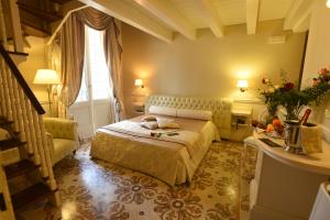 a hotel room with a bed and a window at SANTA CHIARA SUITE HOTEL & SPA - Lecce in Lecce