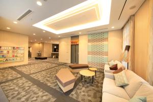 a waiting room with a couch and a table at Richmond Hotel Sapporo Ekimae in Sapporo +75 photos