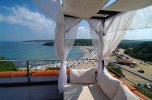 a balcony with a view of a beach and the ocean at Bella Vista Beach Club - All Inclusive in Sinemorets