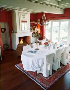 a dining room with a table and a fireplace at Nature et Lin in Néville