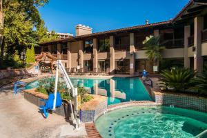 a swimming pool with a surfboard in the middle of it at Best Western Plus Arroyo Roble Hotel & Creekside Villas in Sedona