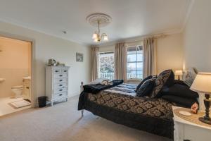 a bedroom with a bed and a window at Bellevue Boutique Lodge in Taupo