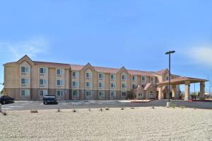 a large building with a parking lot in front of it at Best Western California City Inn & Suites in California City