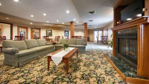 a large living room with couches and a fireplace at Best Western Annawan Inn in Annawan