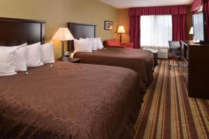 a hotel room with two beds and a television at Best Western Wilsonville Inn & Suites in Wilsonville +17 photos