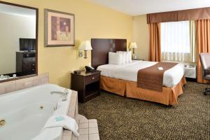a hotel room with a bed and a bath tub at Best Western Elyria in Elyria +18 photos