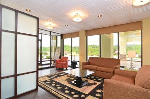 a living room with two couches and a table at Best Western Cades Cove Inn in Townsend