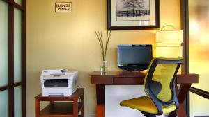 a office with a desk with a computer and a chair at Best Western Cades Cove Inn in Townsend