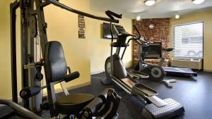 a gym with several exercise equipment in a room at Best Western Cades Cove Inn in Townsend