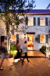 two children walking in front of a house at Zero George Hotel in Charleston