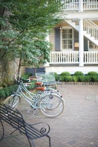 a bike parked next to a bench in front of a house at Zero George Hotel in Charleston