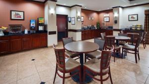 a restaurant with two tables and chairs and a bar at Best Western Plus Katy Inn and Suites in Katy