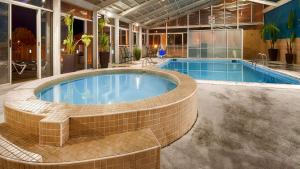 a large swimming pool in a building at Sandcastle Resort in Virginia Beach