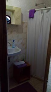 a bathroom with a shower curtain and a sink at Oltremare in Triscina