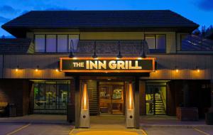 a building with a sign that reads the inn grill at Jasper Inn & Suites by INNhotels in Jasper