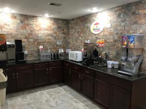 a kitchen with a counter top with a coffee maker at Super 8 by Wyndham Hernando in Hernando