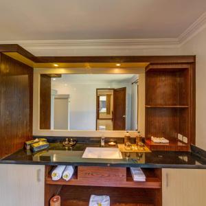 a bathroom with a sink and a large mirror at Vila Ombak in Gili Trawangan