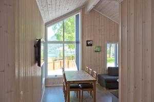 a dining room with a table and a window at Kinsarvik Camping in Kinsarvik