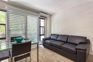 a living room with a couch and a table at Hamilton on Beaumont in Newcastle
