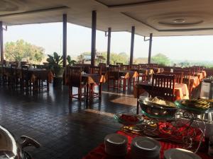 a dining room with tables and chairs and tablesktop at Inle Star Hotel in Nyaungshwe Township