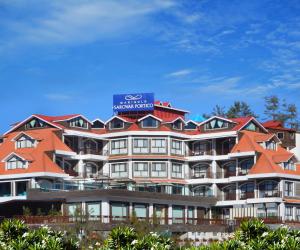 a hotel with orange roofs on top of it at Marigold Sarovar Portico Shimla in Shimla