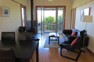 a living room with chairs and a couch and a table at Butterworth Accommodation in Castlemaine