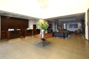 a lobby with a vase of flowers on a table at Casa Andina Select Tacna in Tacna