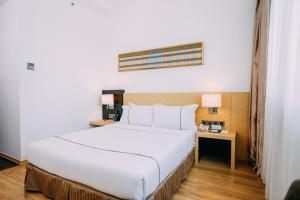 Ένα ή περισσότερα κρεβάτια σε δωμάτιο στο Hotel Granada Johor Bahru