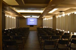 uma sala de conferências com cadeiras e um ecrã em Lagadia 4 Seasons Hotel em Langadia