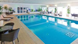 a swimming pool with a pool table and chairs at The Barnstaple Hotel in Barnstaple