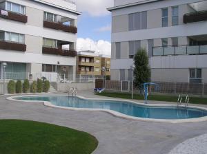 a swimming pool in front of a building at Mirador La Ribera in Santiago de la Ribera