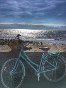 a blue bike with a basket parked on the beach at The Liverpool Arms Hotel in Beaumaris