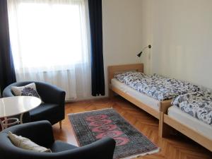 a bedroom with two beds and a table and chairs at Vila Flori in Koper