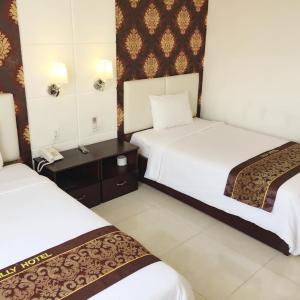Postel nebo postele na pokoji v ubytování Lilly Hotel