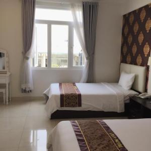 Postel nebo postele na pokoji v ubytování Lilly Hotel