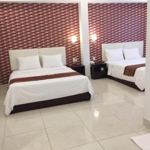 Postel nebo postele na pokoji v ubytování Lilly Hotel