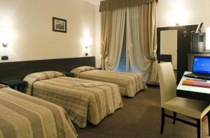 A bed or beds in a room at Hotel Fiera Wellness & Spa