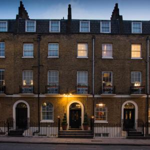 a large brick building with windows and doors at The California - London Kings Cross in London