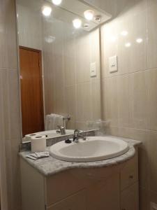 a bathroom with a sink and a mirror at Hospedaria Descansa Pernas in Monchique